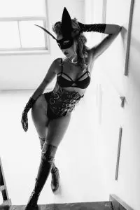 black and white boudoir photography, latex outfit, BDSM, black bunny mask and over the knee black leather boots