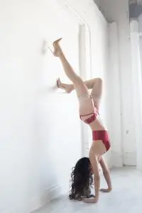 hand stand, brunette model, upside down, red lingerie, white wall, Toronto