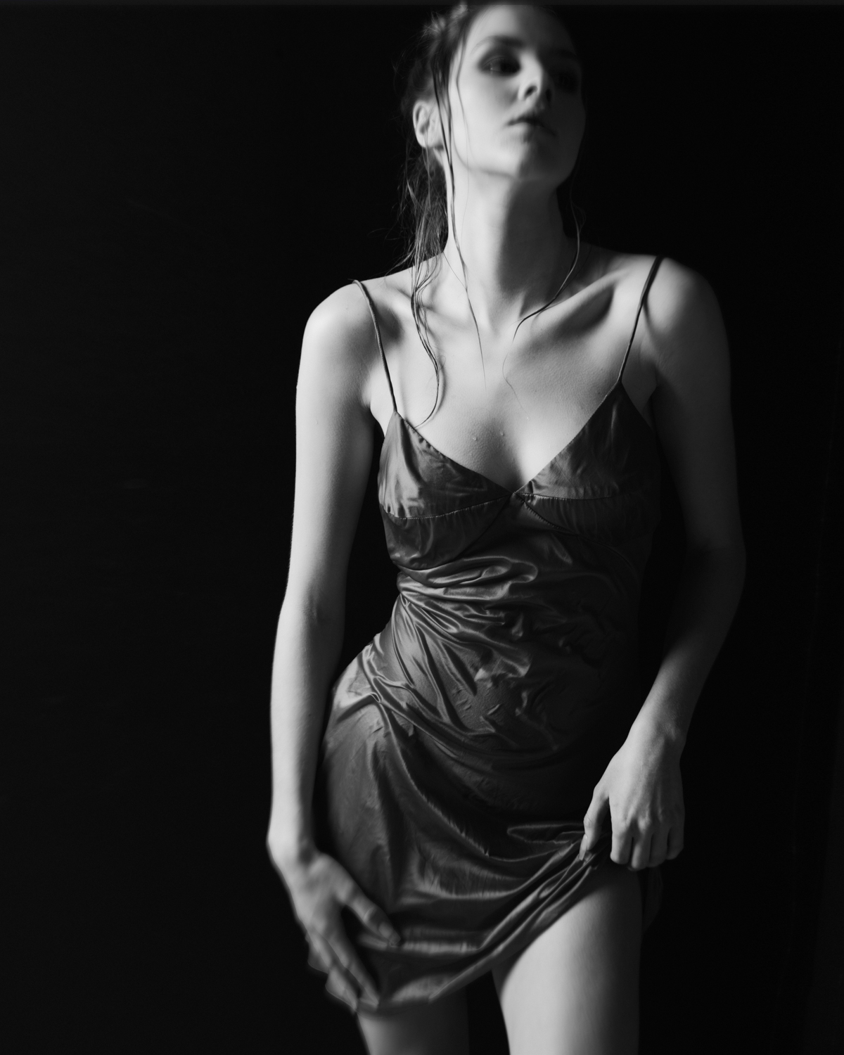 beautiful young woman in a wet silk dress, black and white, collar bones, wet hair, black and white boudoir photography