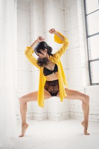 dancer in a yellow shirt, in the moment and black bra, movement photography
