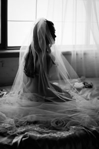 Black and white classy bridal boudoir photography, walking away in long mesh veil