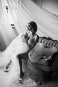Black and white classy bridal boudoir photography, white stilettos and vintage couch