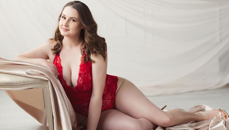 Lady in red lingerie posing for a boudoir photoshoot