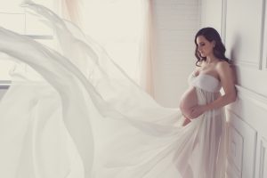 Classy elegant maternity photography Toronto, dreamy, goddess, white dress blowing in the wind