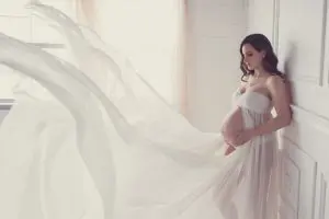 Classy elegant maternity photography Toronto, dreamy, goddess, white dress blowing in the wind